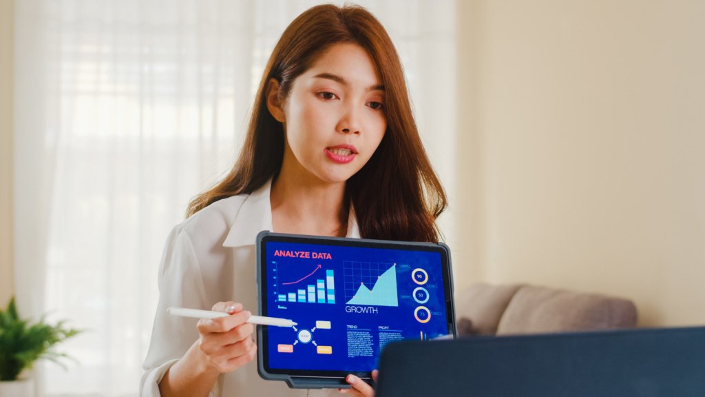 asia businesswoman using laptop tablet presentation colleagues about plan video call while working from home living room self isolation social distancing quarantine coronavirus